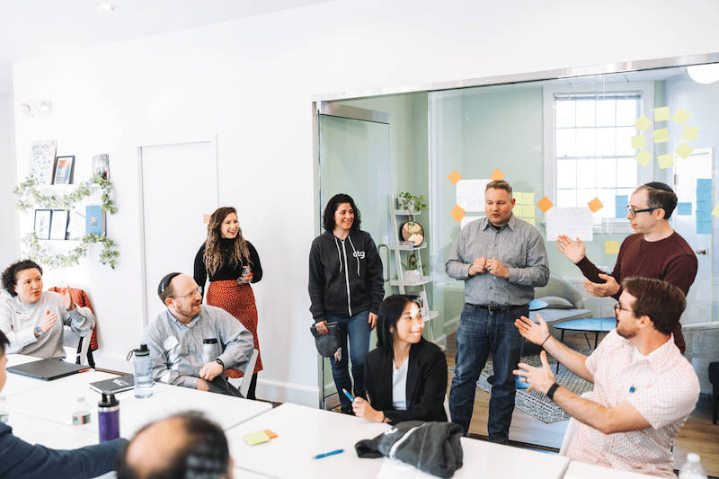 CTG team placing post-it notes on a wall